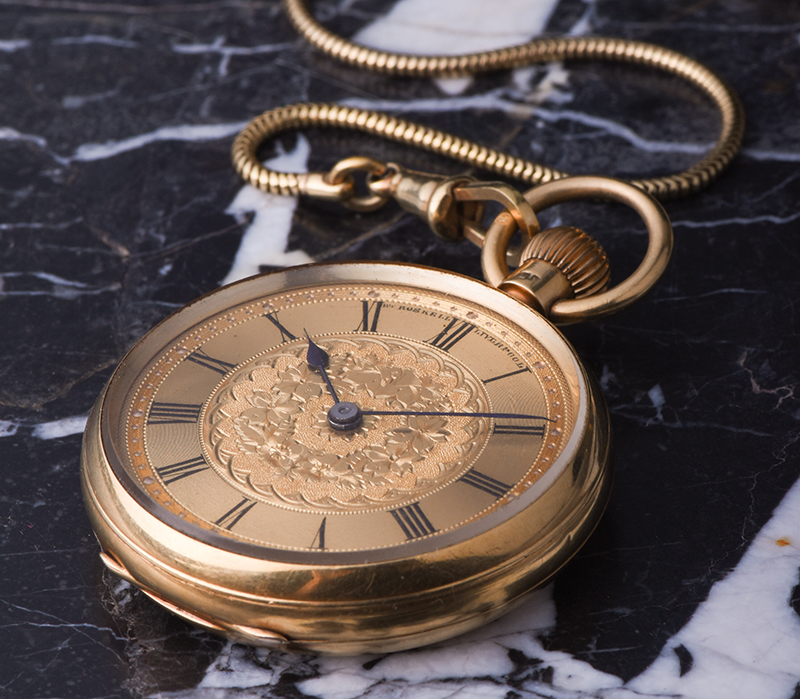 classic gold pocketwatch with visible interior machinery